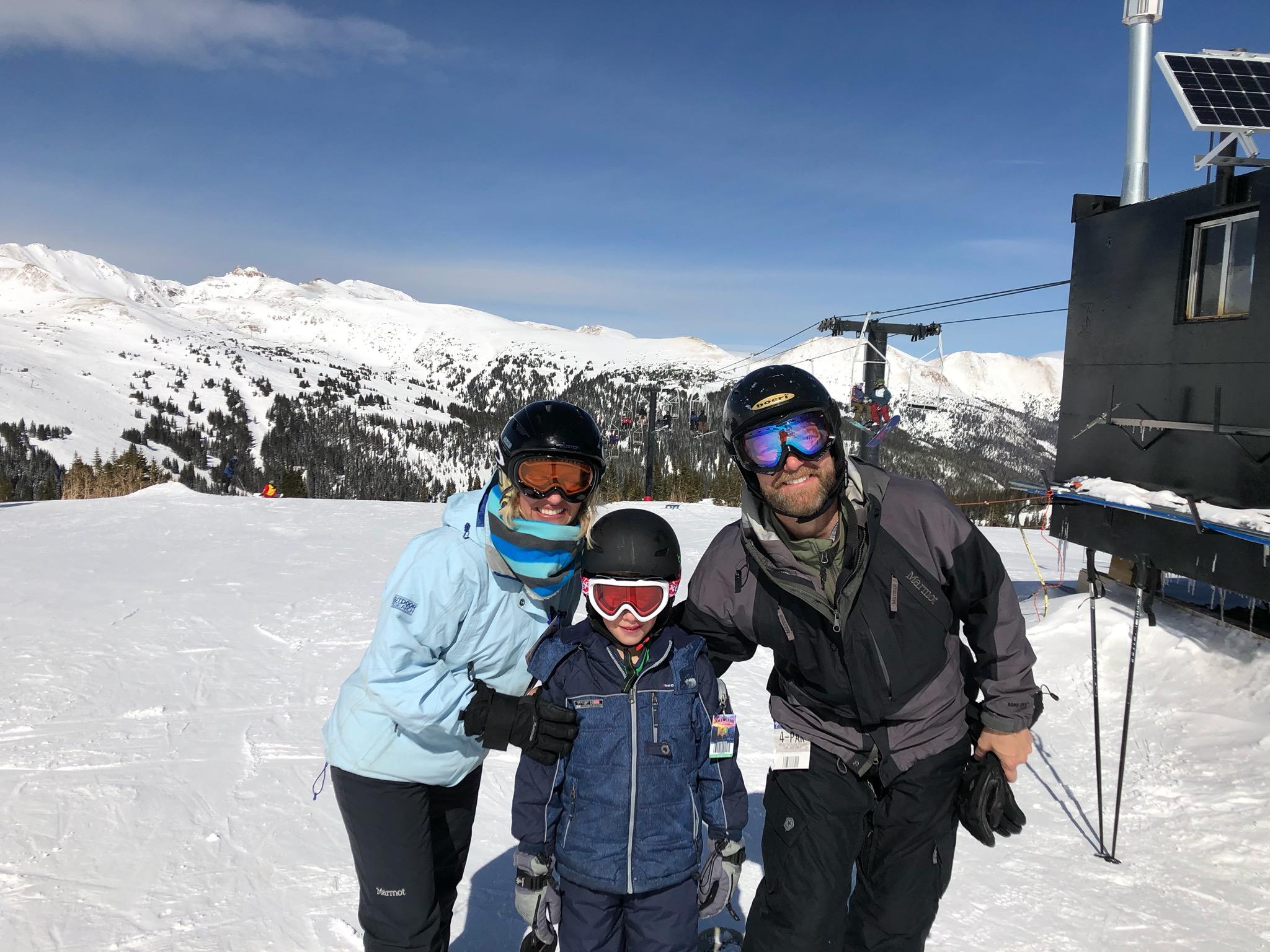 Casie Cook and her family standing on a snow covered mountain.