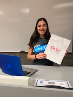 Jeanette Elia with her Gleim swag about to give a presentation for fellow classmates
